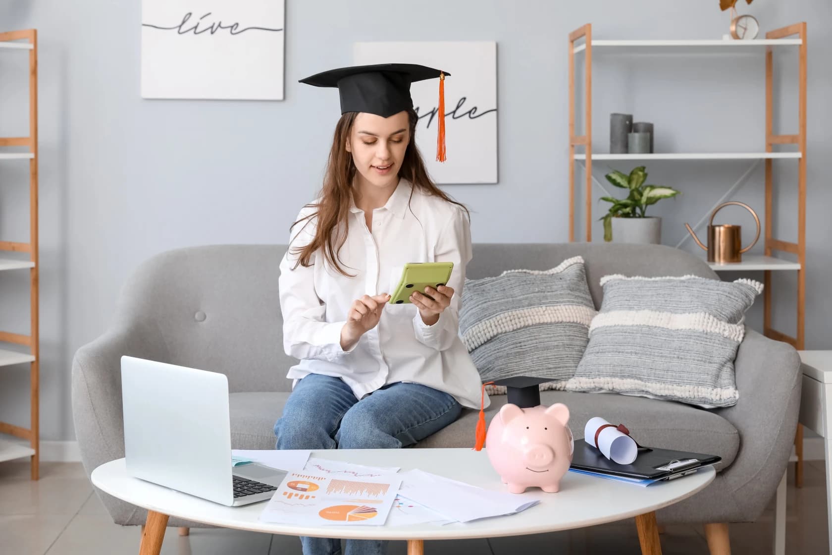 young-canadian-graduate-reviewing-student-loan-documents-and-budget-planning-materials-on-desk-with-calculator-and-laptop